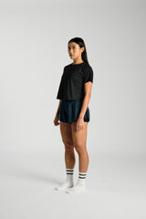 Three quarter angle, in movement, KYDRA Cross Back Tee in Black #color_Black