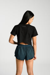 Close view of the cross back detail, KYDRA Cross Back Tee in Black #color_Black