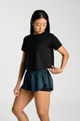 Close detail of the fabric and neckline, KYDRA Cross Back Tee in Black #color_Black
