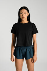 Front view, cropped at the hip, KYDRA Cross Back Tee in Black #color_Black