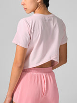 Close view of the cross back detail, KYDRA Cross Back Tee in Pink #color_Pink