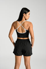 Close view of the cross back straps and hook, KYDRA Lexa Longline Bra in Black #color_Black