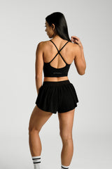 Close view of the back waistband and pleats, KYDRA Pleated Shorts in Black #color_Black