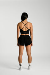 Back view, full length, KYDRA Pleated Shorts in Black #color_Black