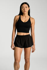 Front view, cropped at the thigh, KYDRA Pleated Shorts in Black #color_Black