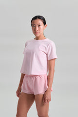 Three quarter angle, in movement, KYDRA Pleated Shorts in Pink #color_Pink